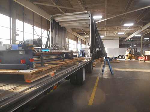 Flatbed Conestoga being loaded